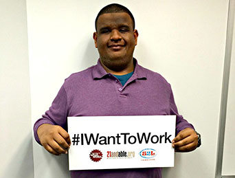 guy holding a I want to work sign